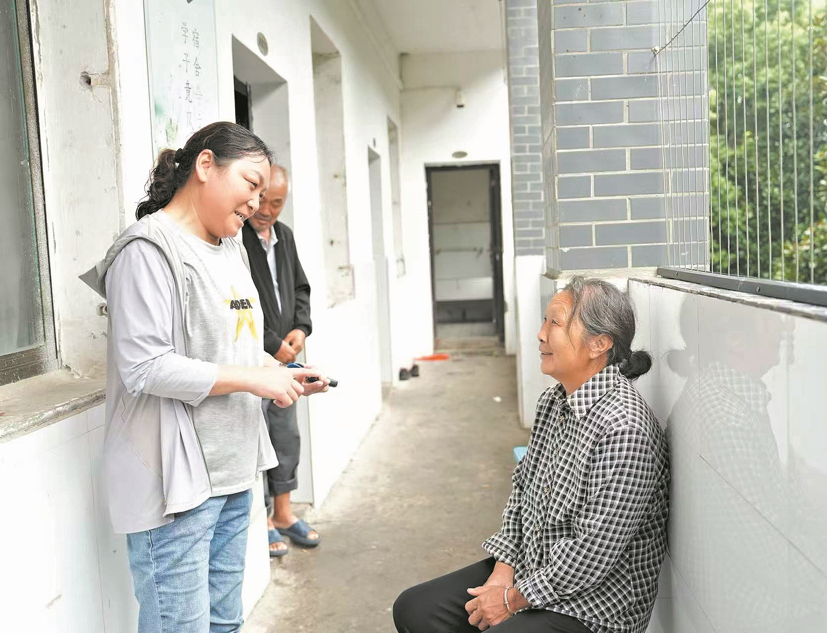8月12日,李成娥(左)和安置点的村民交流。记者 张丽 通讯员 董美丽 齐然然 摄