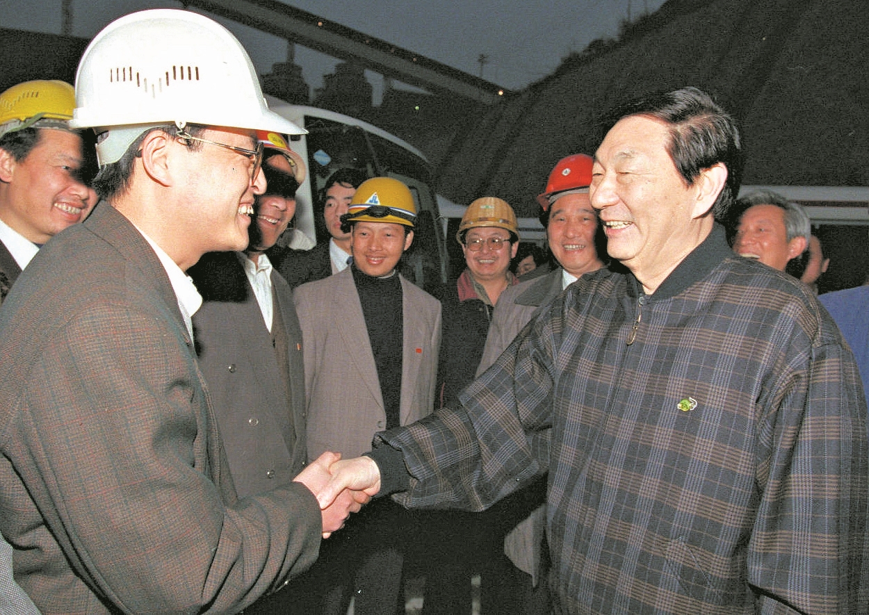1998年12月29日,朱镕基同志在三峡工程施工现场与技术人员亲切握手。 新华社 发